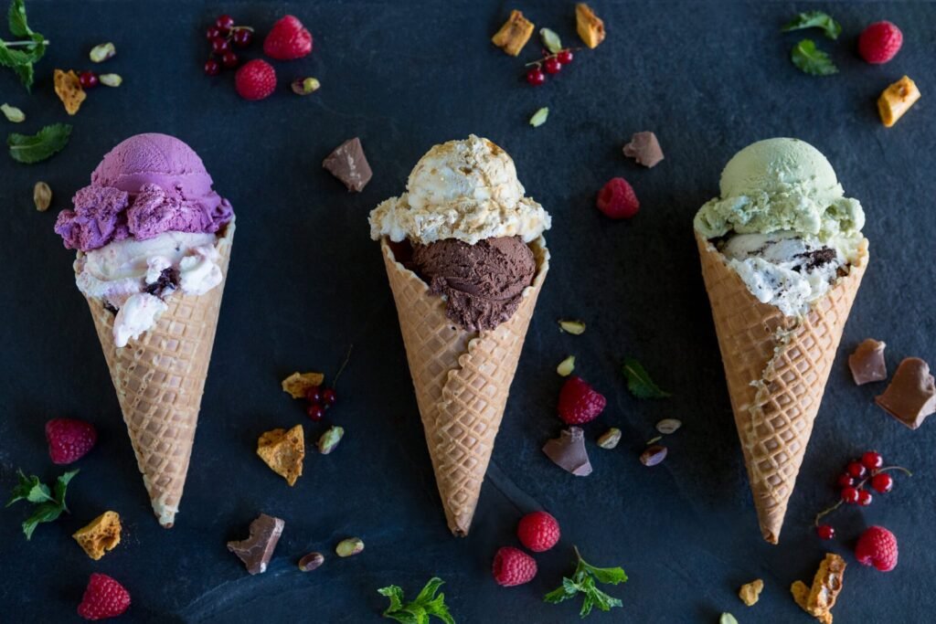 Three waffle cones filled with colourful scoops of Ed’s ice cream